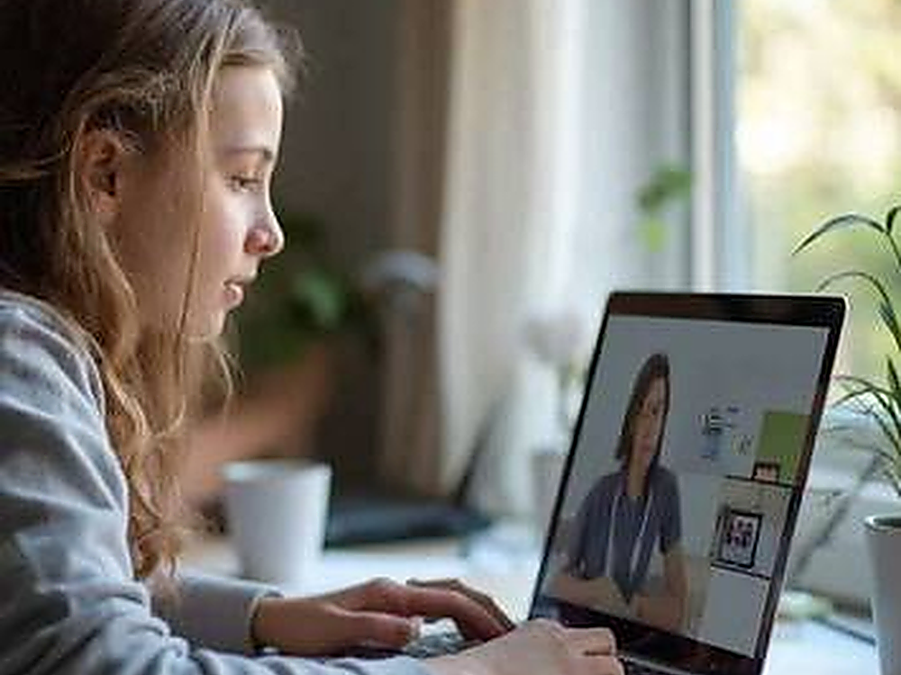Student attending an online lesson on a laptop