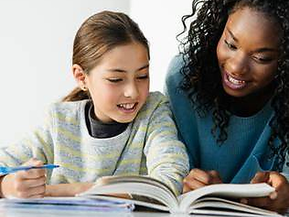 Tutor helping a student read and learn together